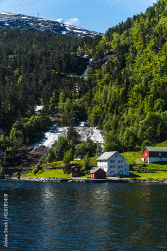 Waterfall behind a house in front of the sea