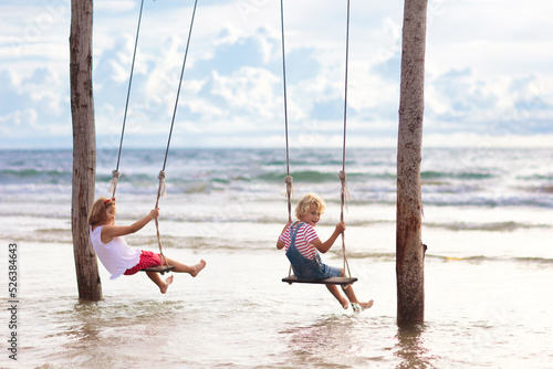 Child on swing. Kid swinging on beach. © famveldman