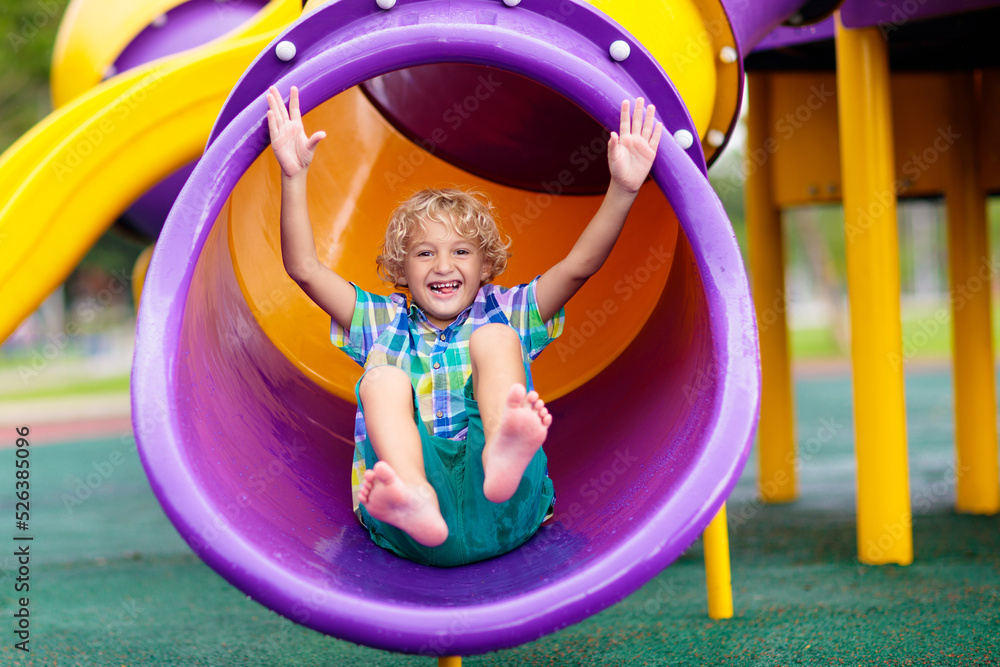 Child on playground. Kids play outdoor.