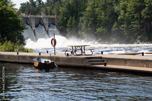 Fototapeta boat beside a cement pier at a dam on the Trent Severn Waterway in Ontario, Cana
