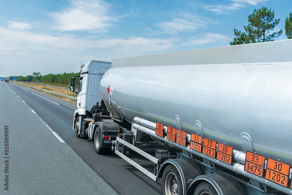 Fuel tanker truck circulating on the highway with orange panels