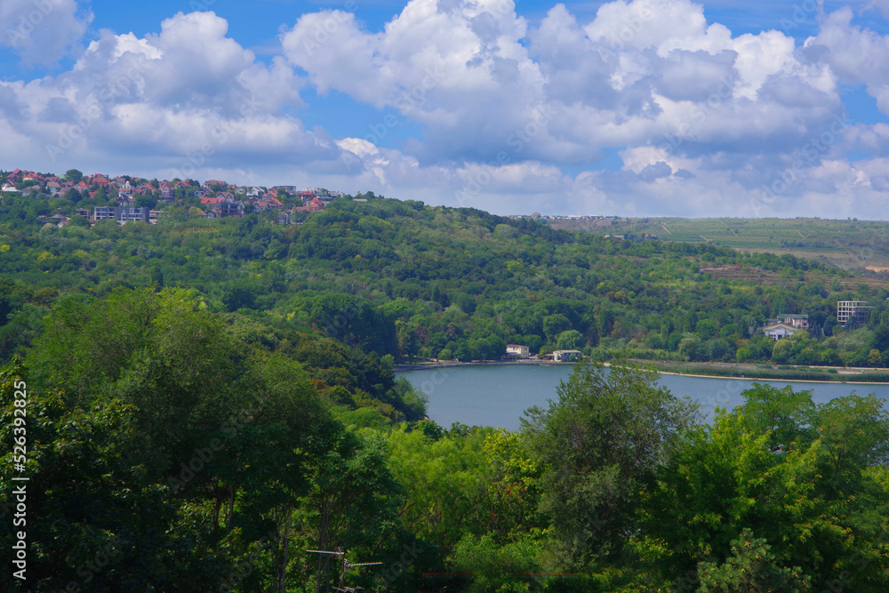 Chisinau. Moldova. View from a height of the lake and dense thickets of trees around.