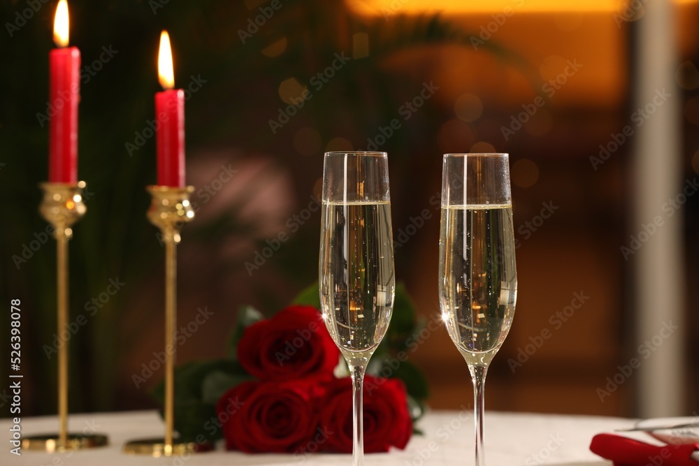 Glasses of champagne on table in restaurant. Romantic dinner Glasses of champagne on table in restaurant. Romantic dinner
