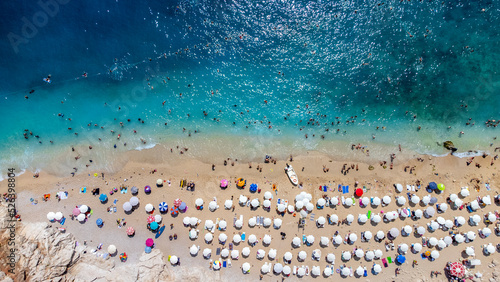 Aerial view of a crowded beach, umbrellas and people on the sand stock photo - Antalya, Kaş