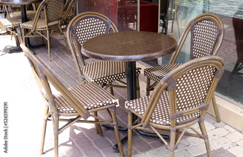 A chair in a city park on the seashore.