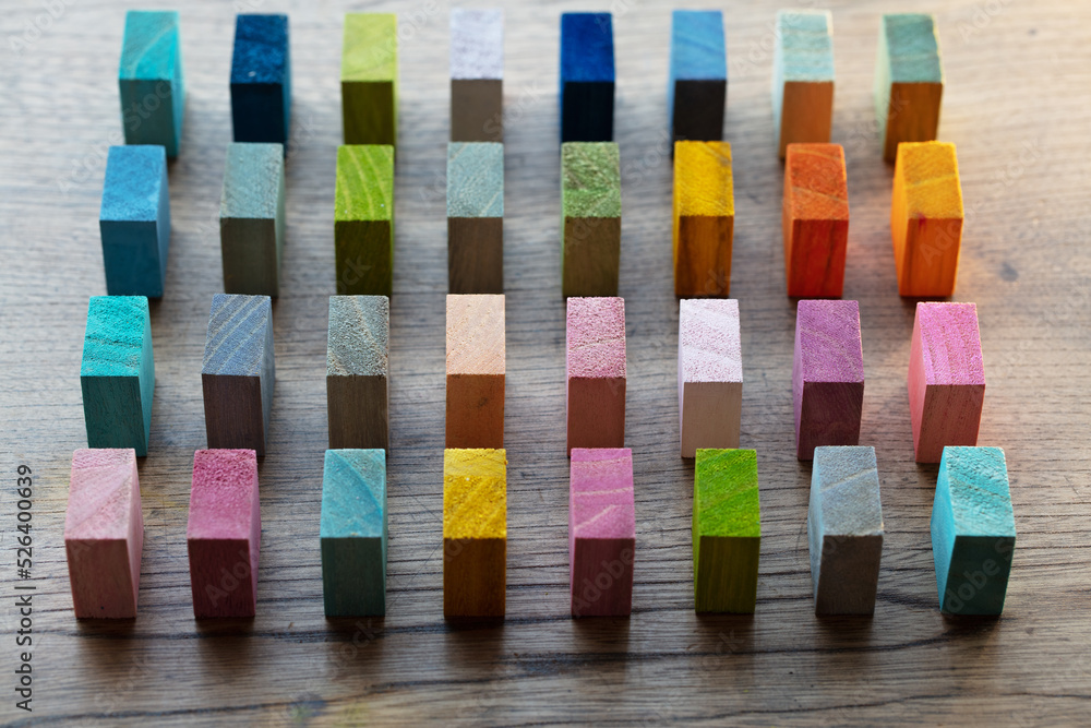 Spectrum of colorful wooden blocks aligned in intervals on a rustic old ...