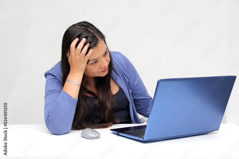 Dark-haired latin adult woman works in her office with laptop with a lot of stress having a headache with a migraine and suffering from tiredness, depression, anxiety and burnout Dark-haired latin adult woman works in her office with laptop with a lot of stress having a headache with a migraine and suffering from tiredness, depression, anxiety and burnout