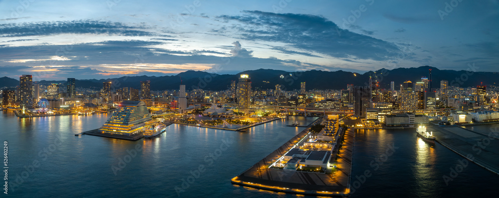 Panoramic aerial view of Kobe City waterfront and skyline at sunset
