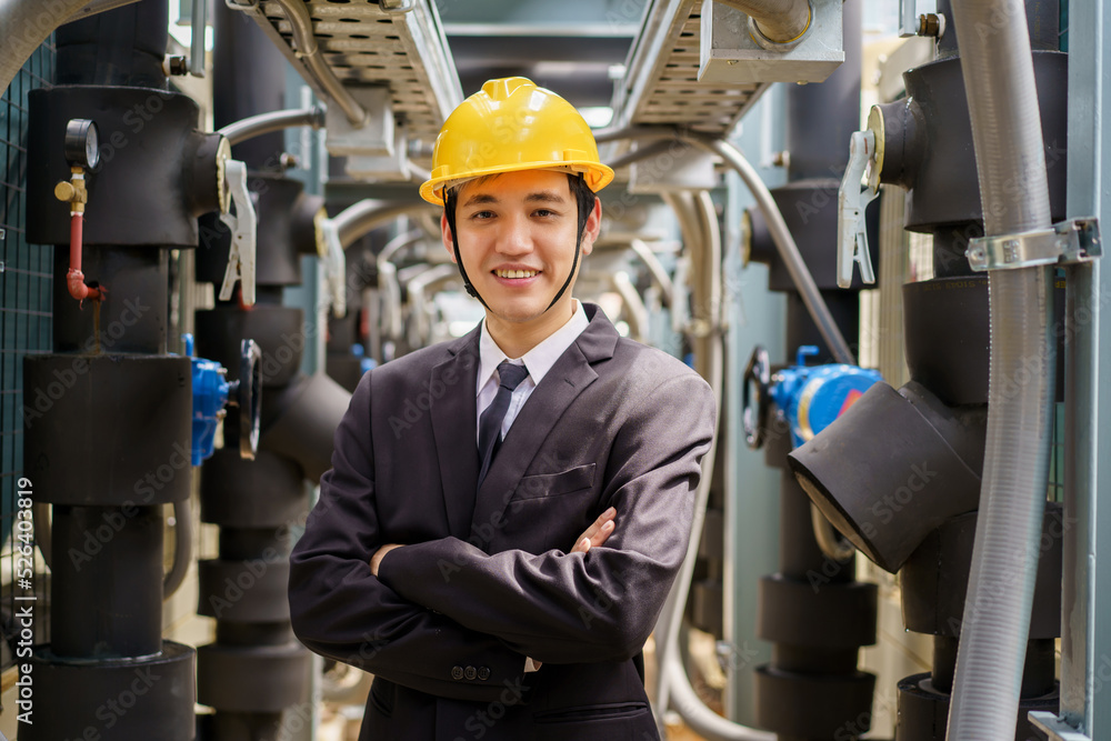 Asian male engineer making arms crossed and smiling to camera. Asian male engineer making arms crossed and smiling to camera.