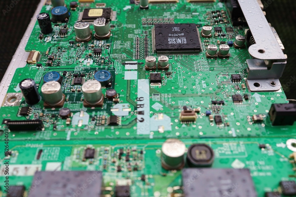 A semiconductor on a printed circuit board wet from the rain.Image: recession, bankruptcy. A semiconductor on a printed circuit board wet from the rain.Image: recession, bankruptcy.