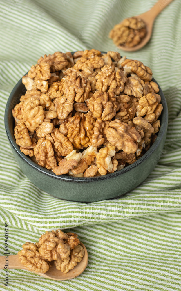 wallnut in ceramic bowl on green tablecloth in kitchen wallnut in ceramic bowl on green tablecloth in kitchen