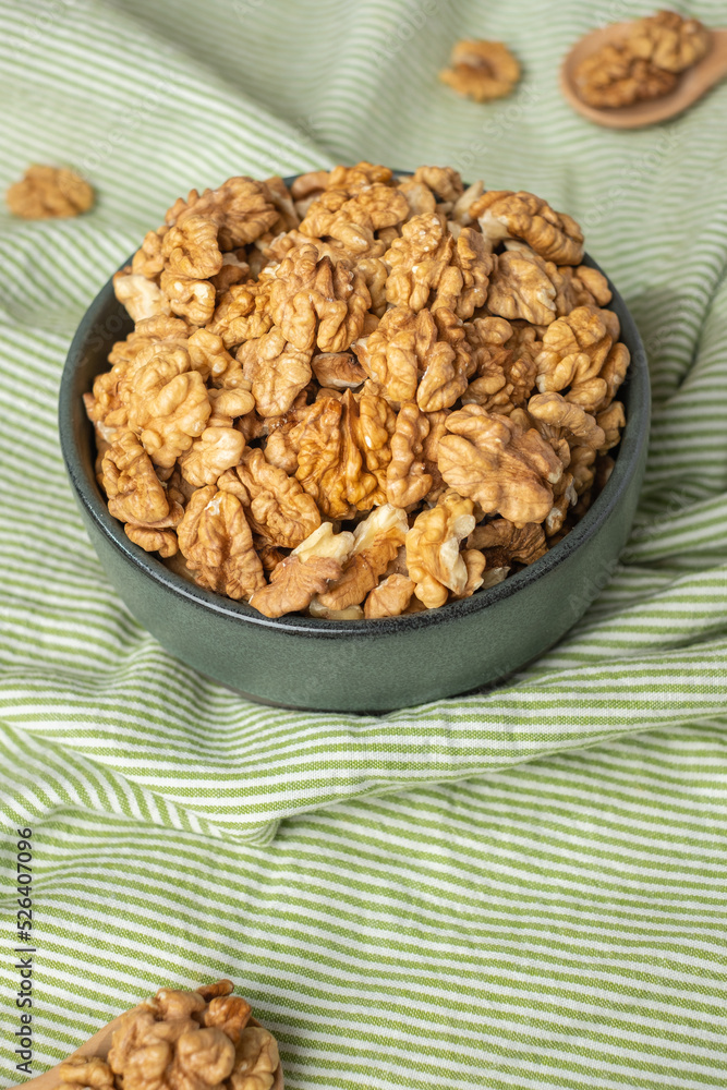 wallnut in ceramic bowl on green tablecloth in kitchen wallnut in ceramic bowl on green tablecloth in kitchen