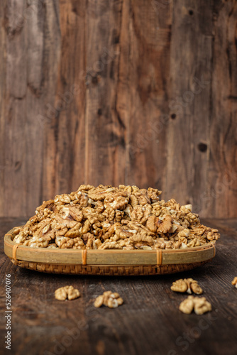 walnut on wicker tray on kitchen wood table