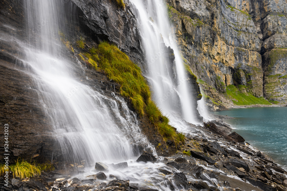 Mystic waterfall at Lake Oeschinen in the Bernese Alps, Switzerland 