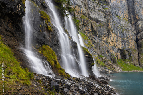 Mystic waterfall at Lake Oeschinen in the Bernese Alps, Switzerland 