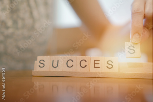 business successful concept,hand og woman arrange wooden cube blocks in 