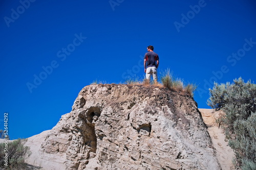 Low angle view of mature man standing on the rock