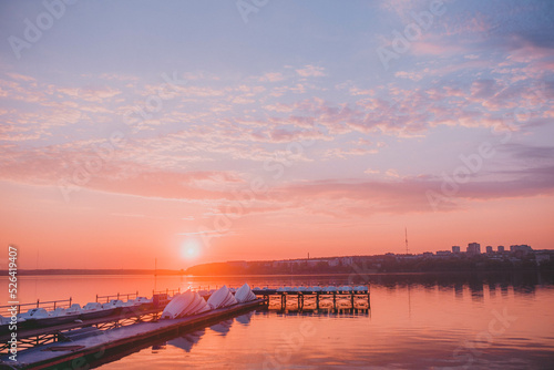 wooden pier with boats at sunset