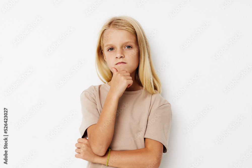 Little cute girl beige t-shirts grimace cropped view Little cute girl beige t-shirts grimace cropped view