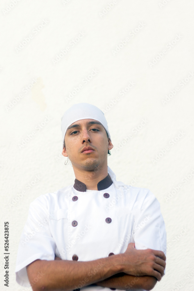 Young Chef smiles at camera on white background space for design Young Chef smiles at camera on white background space for design