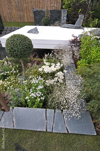 A modern Japanese white garden with flowers photo