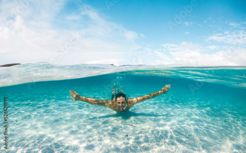 Man swimming in crystal clear water