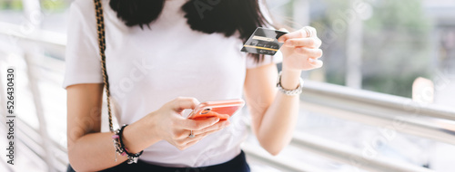 Canvas-taulu Adult woman consumer using creadit card and smartphone shopping via online application for spending money cashless