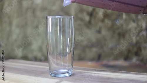 glass filling up with fruit smoothie 
