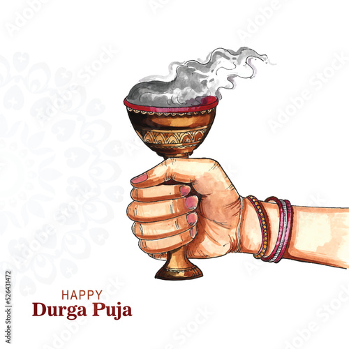 Hand holding durga puja clay dhunuchi with smoke indian puja festival background