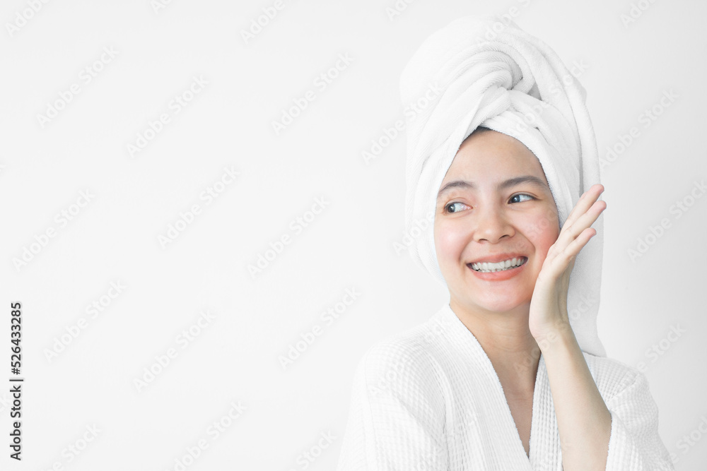 Beautiful Asian woman wearing bathrobe on white background, Face care, Skin care, Facial treatment, Cosmetology, beauty and spa Concept. Beautiful Asian woman wearing bathrobe on white background, Face care, Skin care, Facial treatment, Cosmetology, beauty and spa Concept.