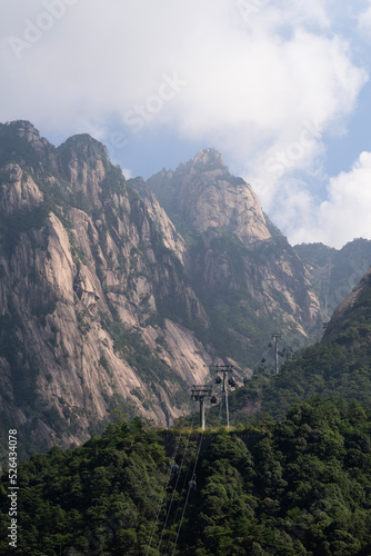 cable cars passing through the mounatin in a cloudy day