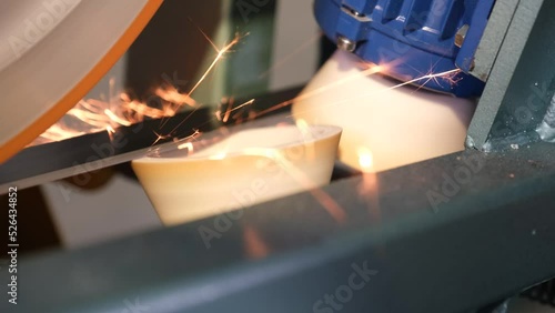 Special workbench sharpens metal blade  leaving orange sparks photo