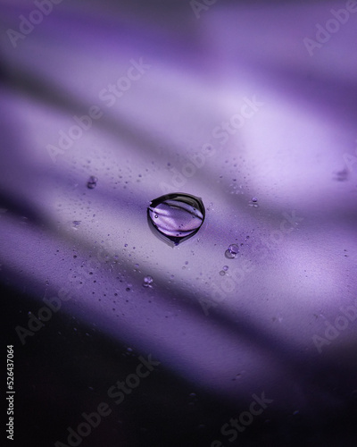 drop of water on purple glass floor 