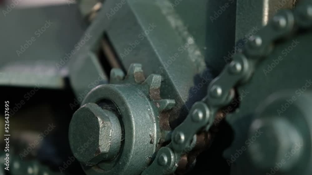Closeup of rotating gears and chains on industry machine Closeup of rotating gears and chains on industry machine