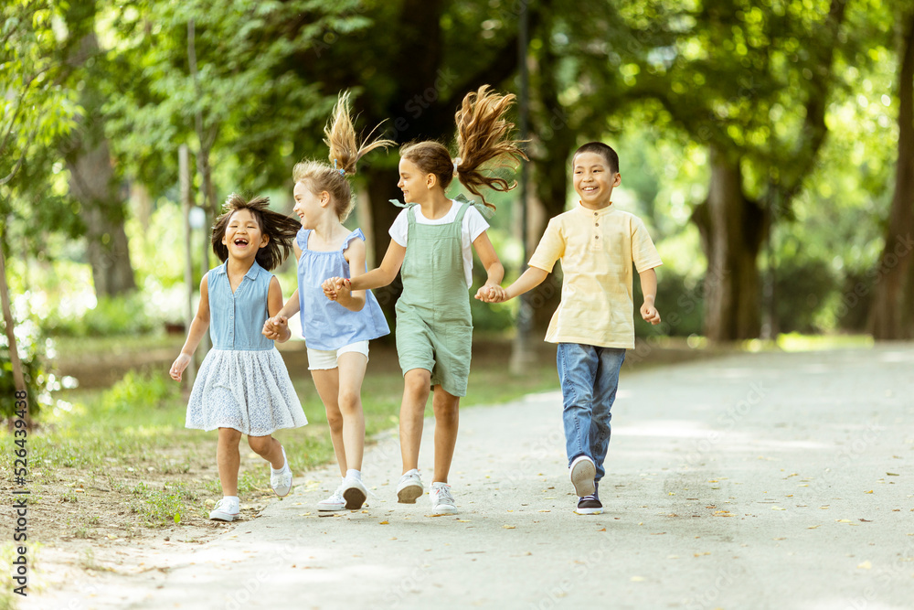 Group of asian and caucasian kids having fun in the park Group of asian and caucasian kids having fun in the park