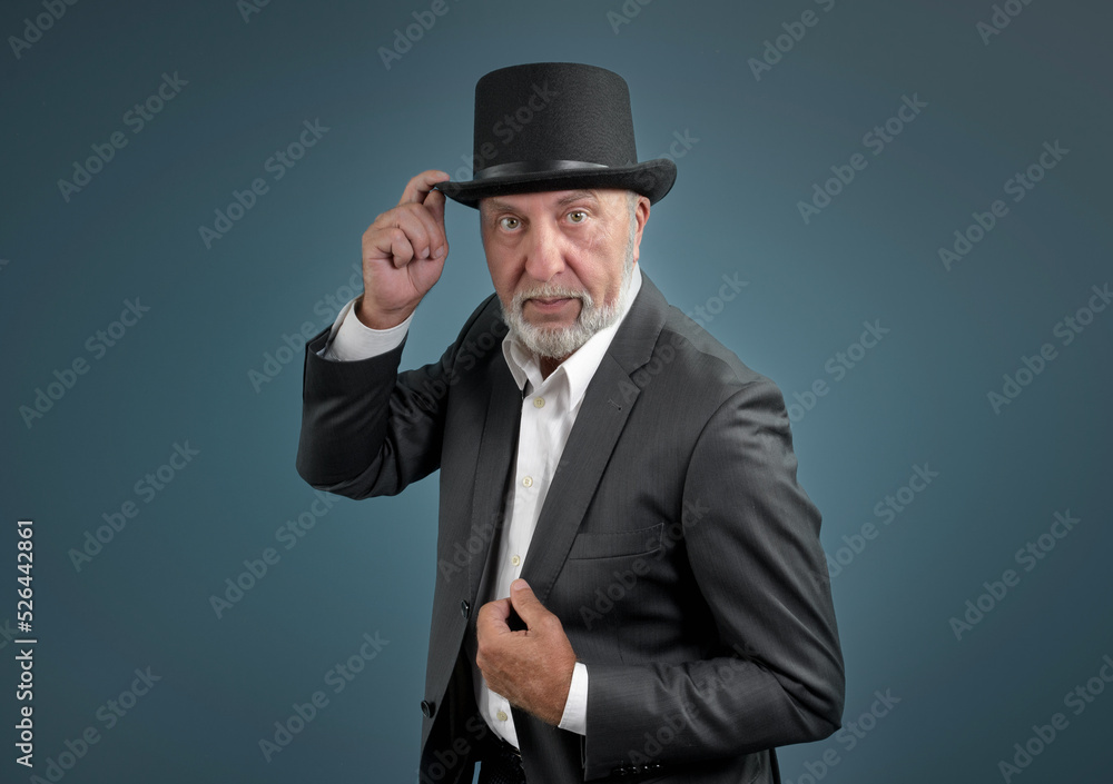 An imposing elderly man in a suit and a top hat An imposing elderly man in a suit and a top hat