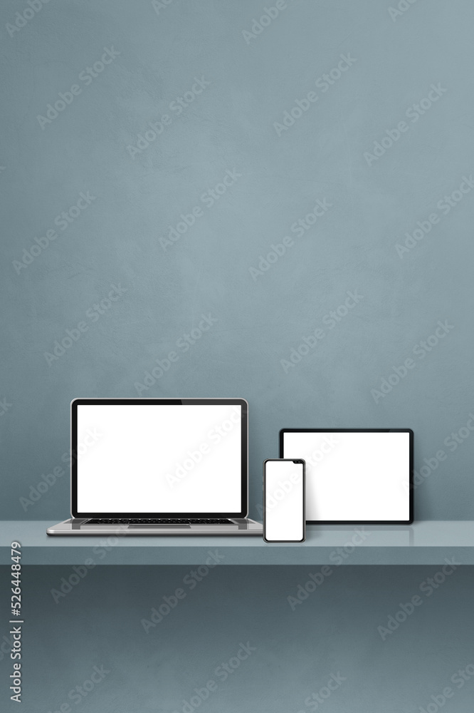 Laptop, mobile phone and digital tablet pc on grey wall shelf. Vertical background Laptop, mobile phone and digital tablet pc on grey wall shelf. Vertical background