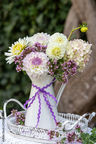 Blumenstrauß mit lila und weißen Dahlien. Hortensien-Blüten und Feldthymian im vintage Krug