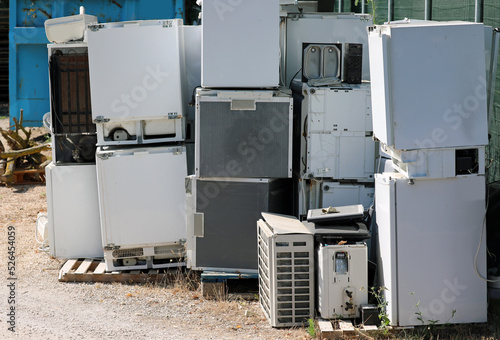 Broken used appliances in the landfill for the recovery of polluting materials photo