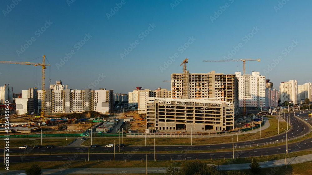 Construction site of a new city block. Construction of multi-storey buildings. Construction site at dawn. Aerial photography.