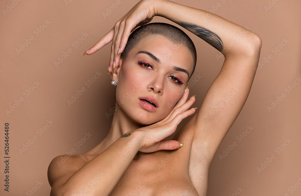 Beautiful woman with short shaved hair portrait on colored background, concept about beauty and skin care - obrazy, fototapety, plakaty 