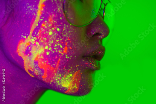 Obraz na plátne Fashion model with fluo painting on the face - Creative fashion portrait of youn