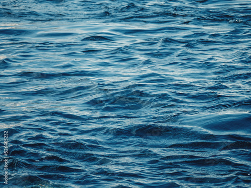 Dark blue water with waves. Ocean, sea or deep river surface. Liquid background.
