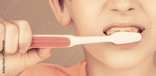 Health care  dental hygiene. Joyful child shows toothbrushes. Little boy cleaning teeth. Kid boy brushing teeth. Boy toothbrush white toothpaste. Dental hygiene. Happy little kid brushing her teeth