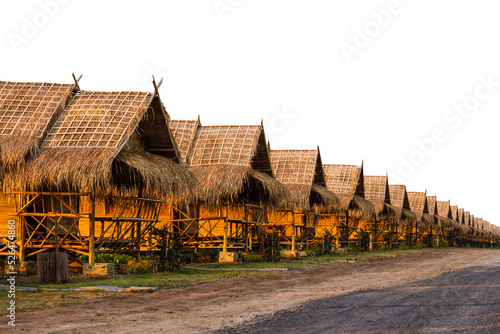 Fototapeta Isolate rows of thatched bamboo huts, shacks with thatch roofs sunlight shining through the room