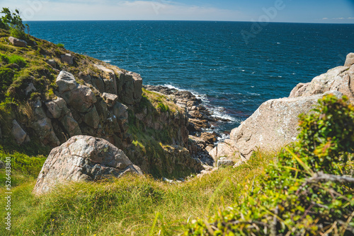Fotografie steep cliffs and green landscape of nothern Bornholm coastline at baltic sea, De