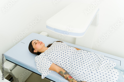 Latin young woman getting a densitometry test at the lab photo