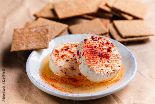 Tomini with chilli pepper, soft cheese from Piedmont region, Italy