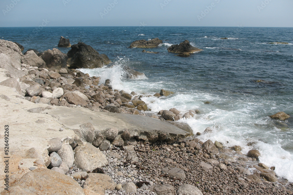 Rocky seashore with big stones during the day