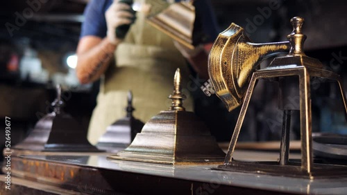 Wallpaper Mural A restorer in the workshop restores decorative street lights. Painting of a forged frame for street lamps. Torontodigital.ca